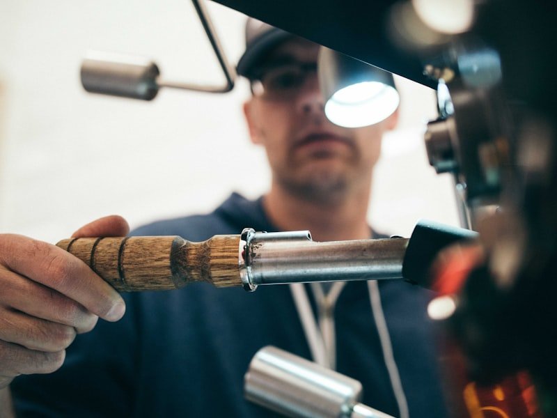 Plumber responding to a burst-pipe emergency under a sink